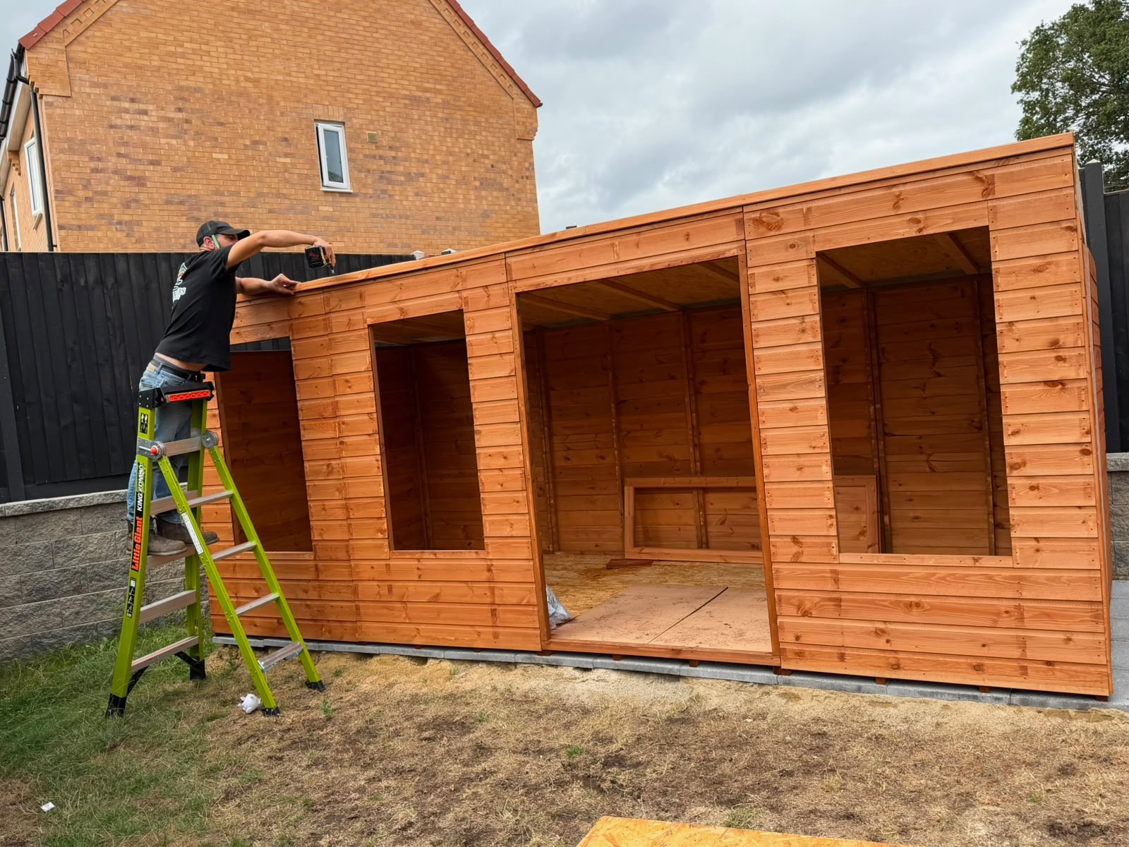 Completed timber garden building with felt roof